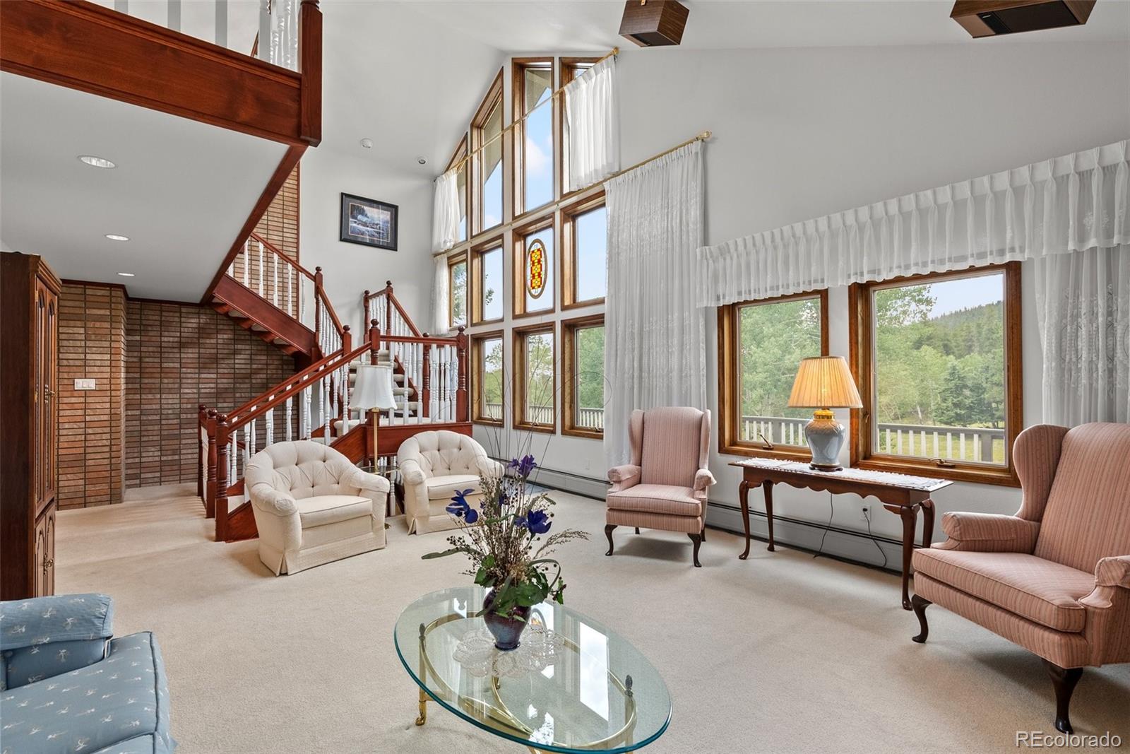 1680 Crow Valley Road Bailey, CO 80421 - Photo 9 of 50 a living room with furniture and a large window