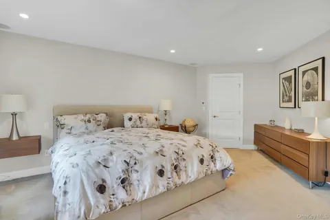 a bedroom with a large bed and a large window