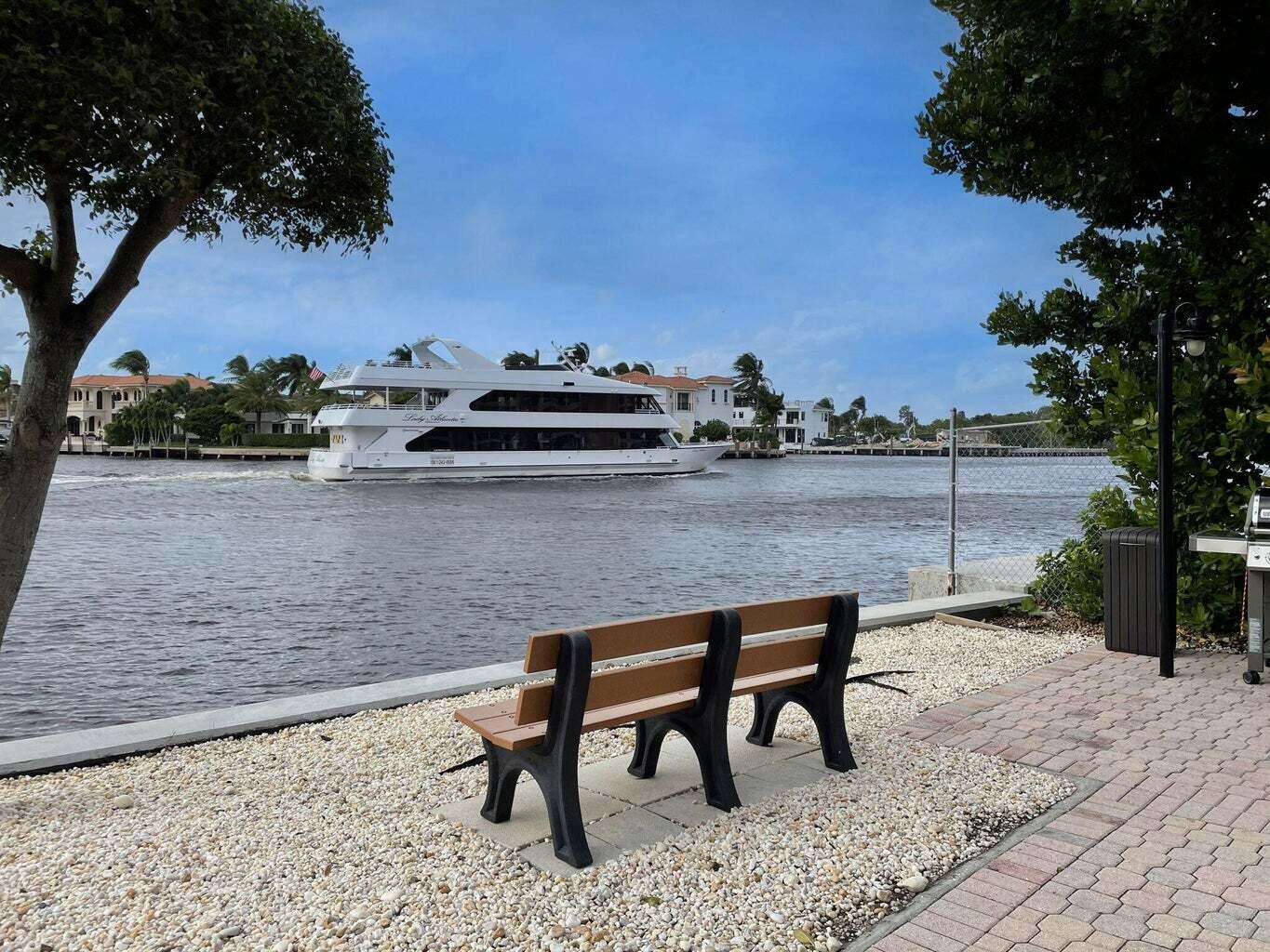 2707 North Ocean Boulevard, Unit D205 Boca Raton, FL 33431 - Photo 51 of 51 a view of a bench in a backyard