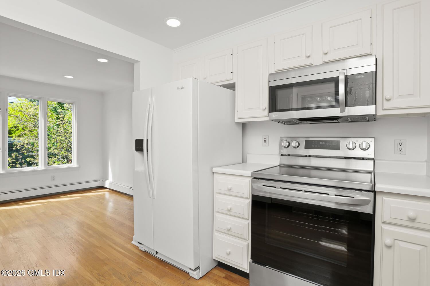 22 Grigg Street, Unit 2 Greenwich, CT 06830 - Photo 8 of 11 a kitchen with stainless steel appliances a stove microwave and white cabinets