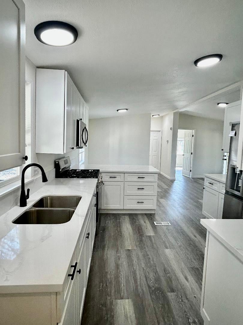 790 Los Verjeles Road Bangor, CA 95901 - Photo 31 of 97 a kitchen with stainless steel appliances granite countertop a sink a stove and a wooden floors