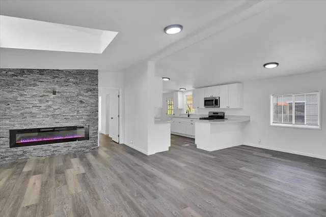 a view of a forest with mountains in the background