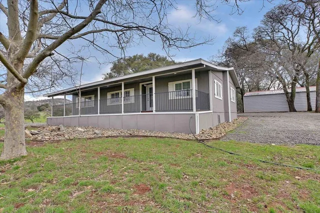 a view of a house with a yard and sitting space