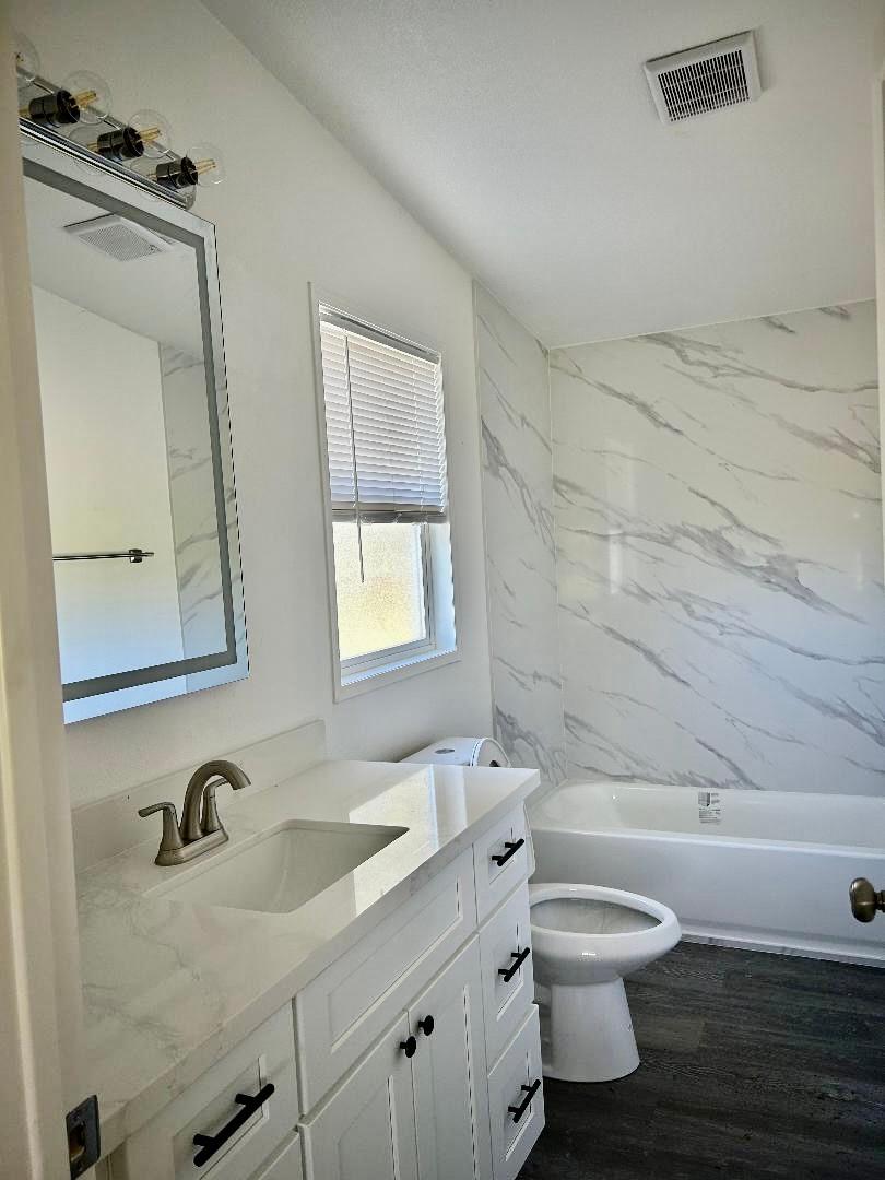 790 Los Verjeles Road Bangor, CA 95901 - Photo 78 of 97 a bathroom with a granite countertop toilet sink mirror and vanity