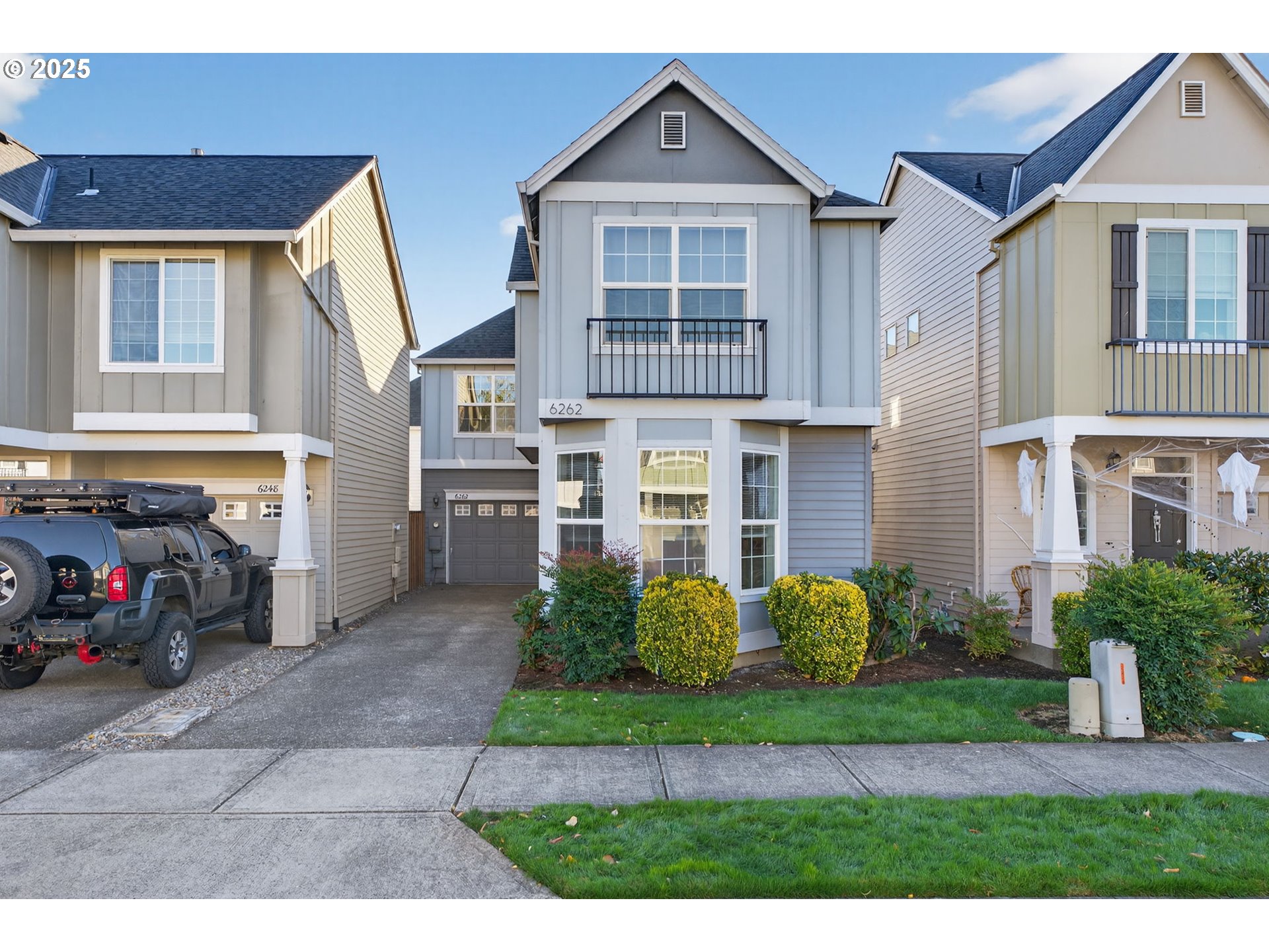 a front view of a house with a garden and plants