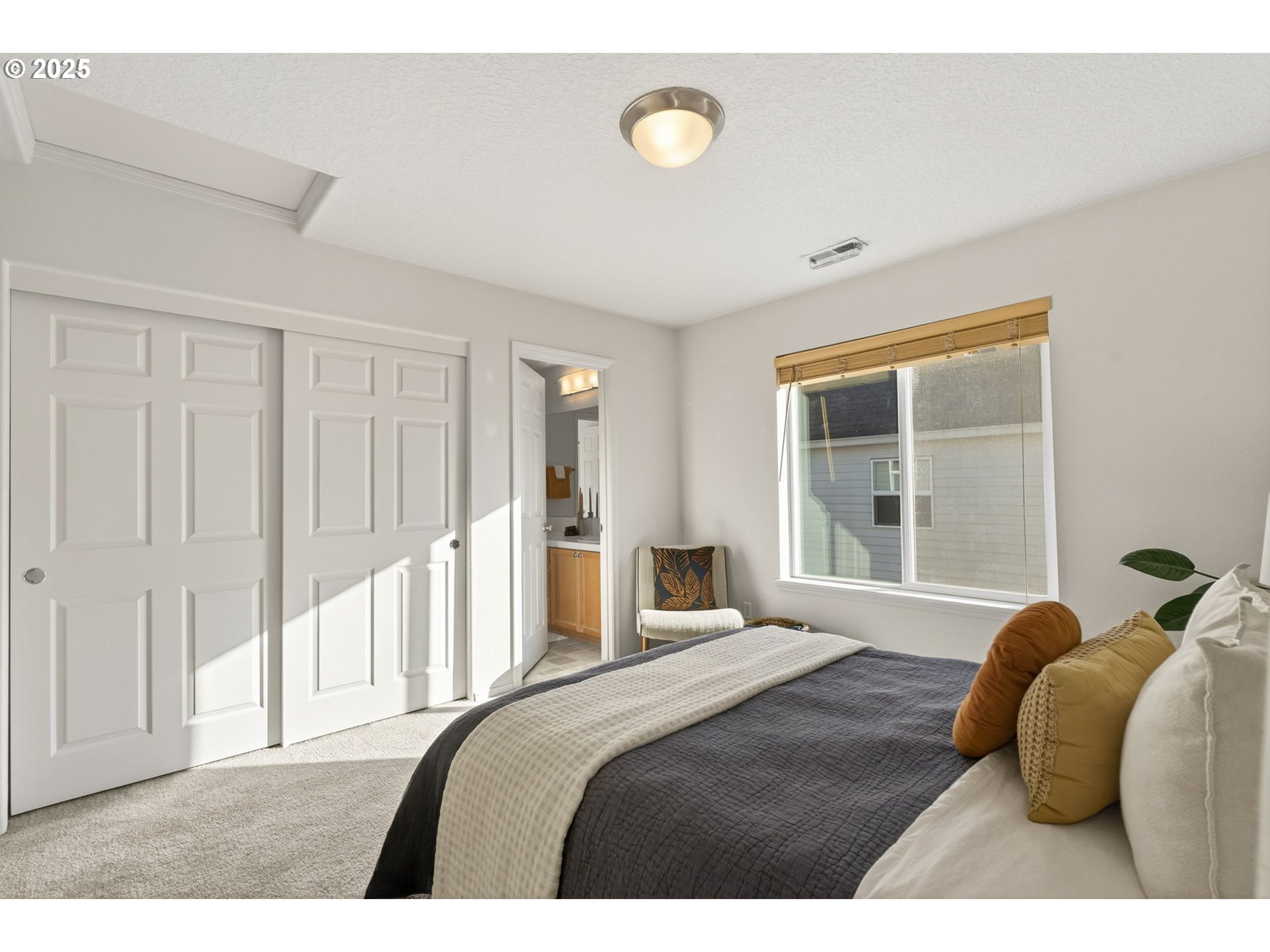 6262 Southwest 205th Avenue Beaverton, OR 97078 - Photo 30 of 36 a bedroom with a bed and a large window
