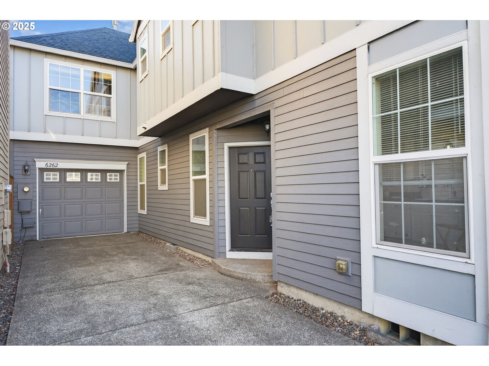 6262 Southwest 205th Avenue Beaverton, OR 97078 - Photo 3 of 36 a view of a house with a door and wooden walls