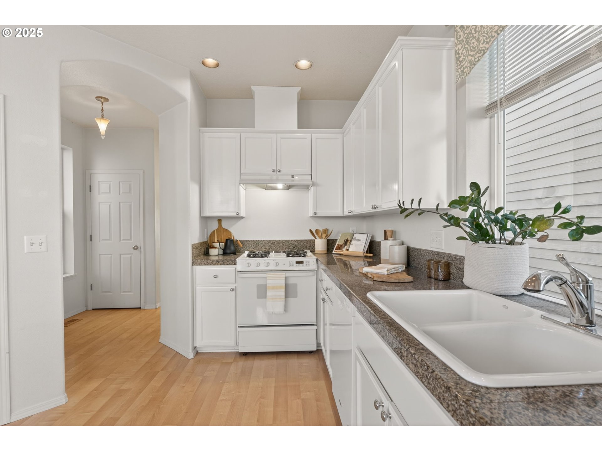 6262 Southwest 205th Avenue Beaverton, OR 97078 - Photo 5 of 36 a kitchen with a sink stove and white cabinets