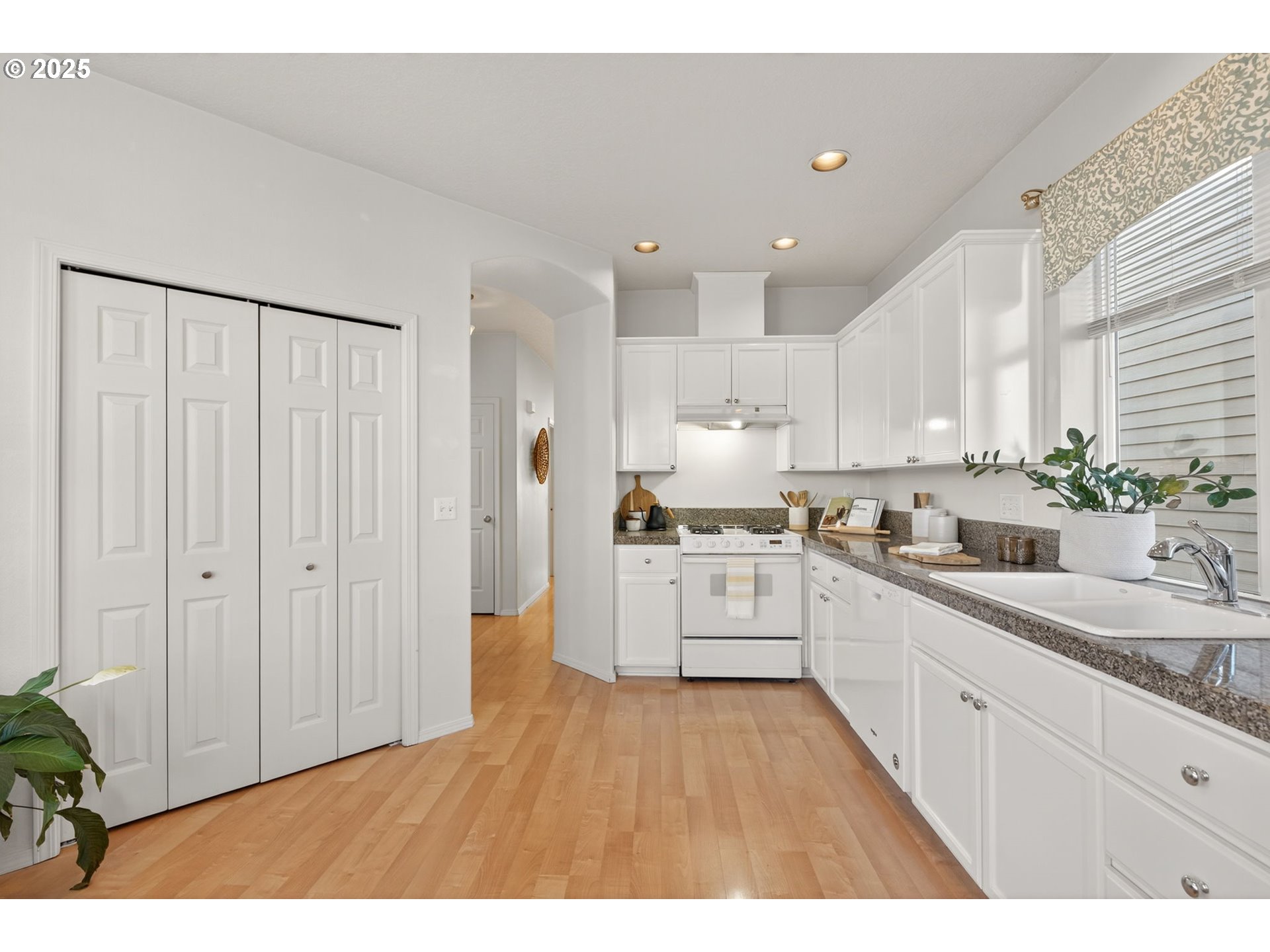 6262 Southwest 205th Avenue Beaverton, OR 97078 - Photo 6 of 36 a kitchen with stainless steel appliances sink refrigerator and cabinets