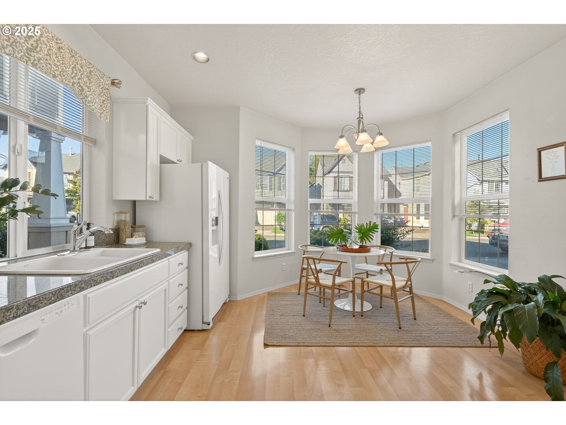 6262 Southwest 205th Avenue Beaverton, OR 97078 - Photo 7 of 36 a view of a dining room and livingroom with furniture wooden floor a chandelier