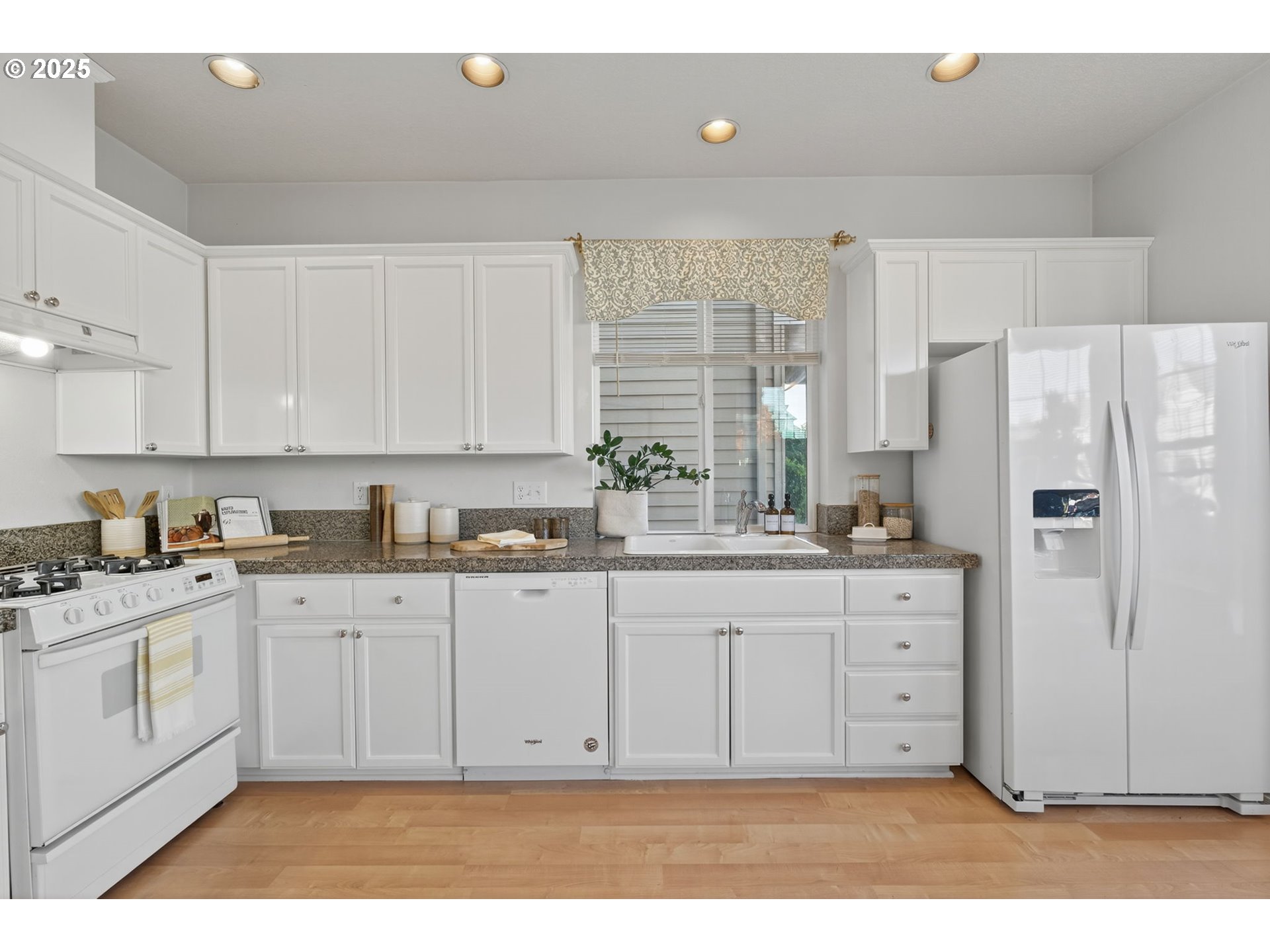 6262 Southwest 205th Avenue Beaverton, OR 97078 - Photo 8 of 36 a kitchen with granite countertop a refrigerator sink and cabinets