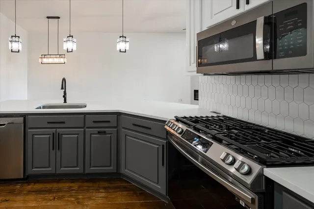 a kitchen with a stove and a microwave