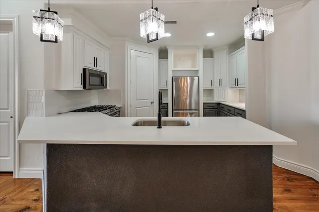 a kitchen with kitchen island granite countertop counter top space and stainless steel appliances