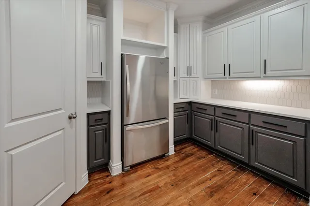 a kitchen with stainless steel appliances granite countertop a refrigerator sink and cabinets