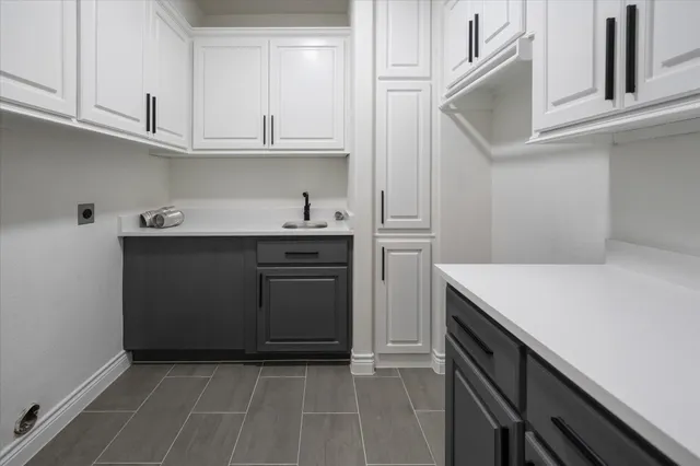 a kitchen with a sink and cabinets
