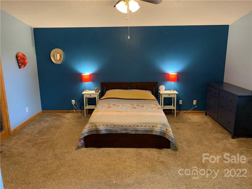 3306 Mt Pleasant Road South Concord, NC 28025 - Photo 12 of 33 a bedroom with a bed and a lamp