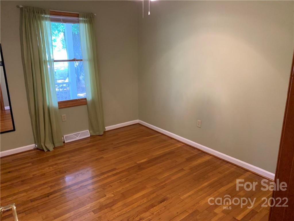 3306 Mt Pleasant Road South Concord, NC 28025 - Photo 17 of 33 a view of empty room with wooden floor and fan