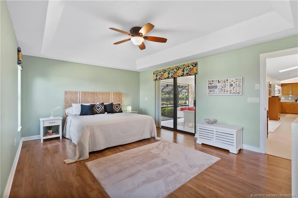 4620 Southeast Quail Trail Stuart, FL 34997 - Photo 32 of 71 a bedroom with a bed and a chandelier
