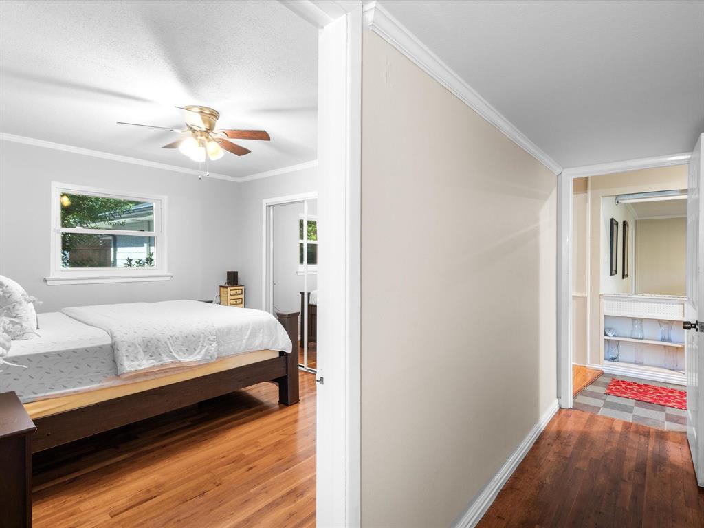 1318 Brook Valley Lane Dallas, TX 75232 - Photo 14 of 39 a bedroom with a bed dresser and a window