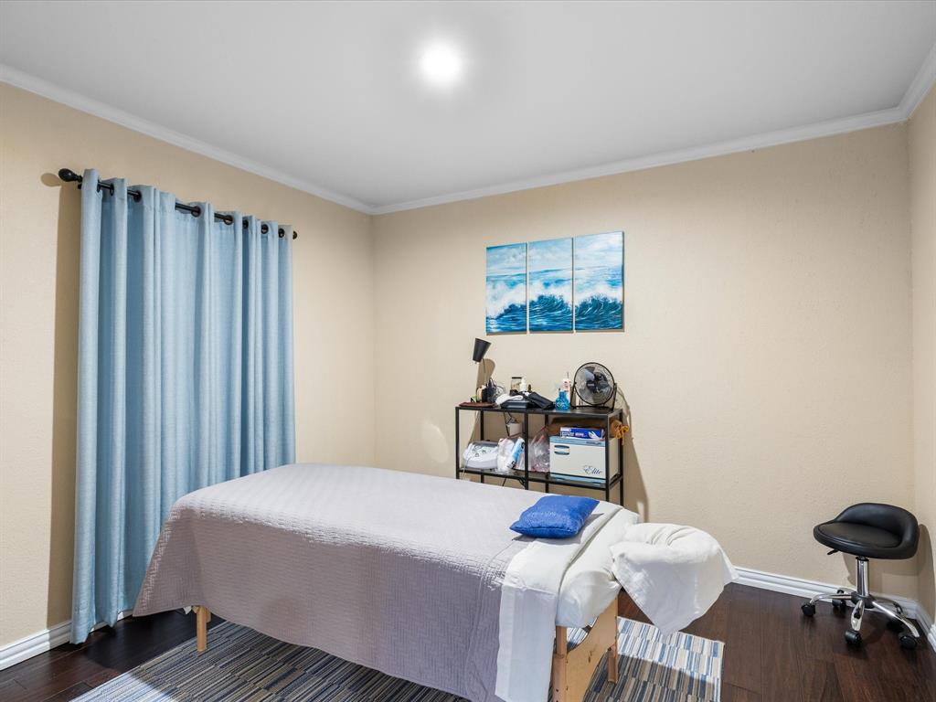 1318 Brook Valley Lane Dallas, TX 75232 - Photo 20 of 39 a bedroom with a bed and a table in it