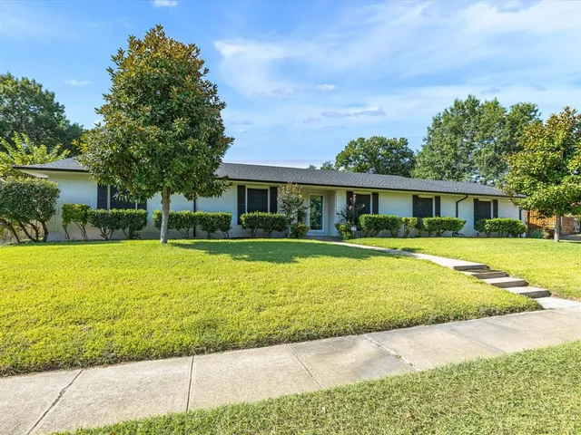a house with swimming pool in front of it