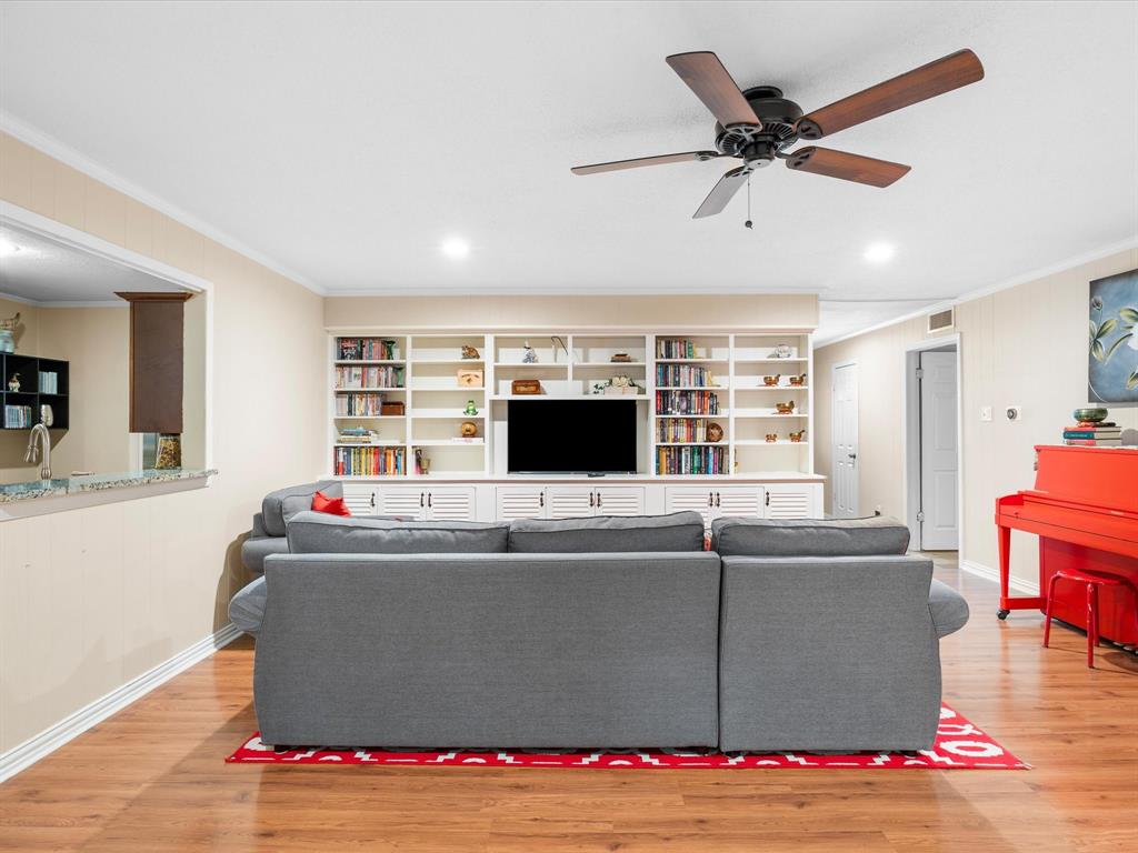 1318 Brook Valley Lane Dallas, TX 75232 - Photo 23 of 39 a living room with furniture and a flat screen tv