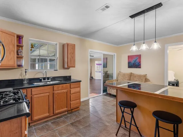 a kitchen with stainless steel appliances granite countertop a stove a sink and a refrigerator