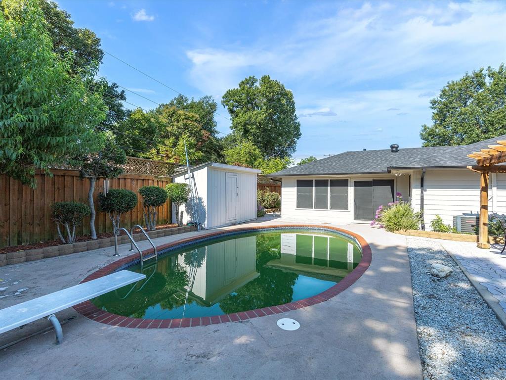 1318 Brook Valley Lane Dallas, TX 75232 - Photo 34 of 39 a house view with a swimming pool and sitting space