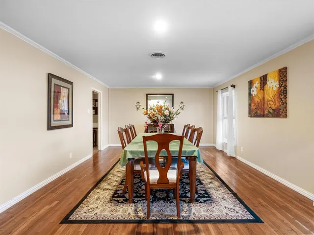 a dining room with furniture and wooden floor