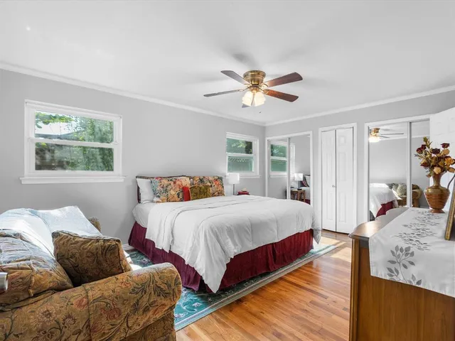 a bedroom with a bed couch and window