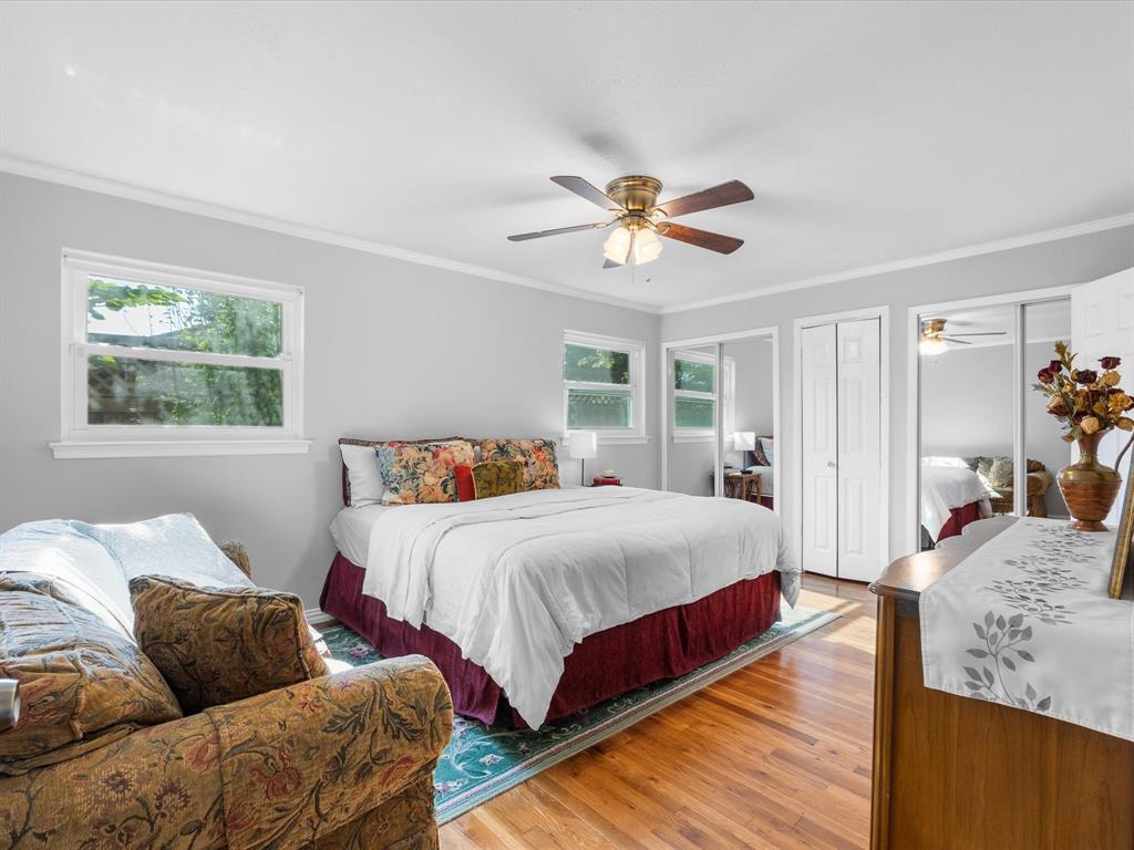 1318 Brook Valley Lane Dallas, TX 75232 - Photo 6 of 39 a bedroom with a bed couch and window