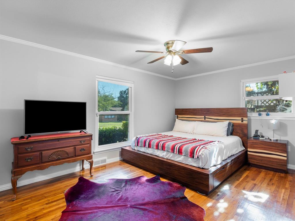 1318 Brook Valley Lane Dallas, TX 75232 - Photo 8 of 39 a bedroom with a bed and a flat screen tv