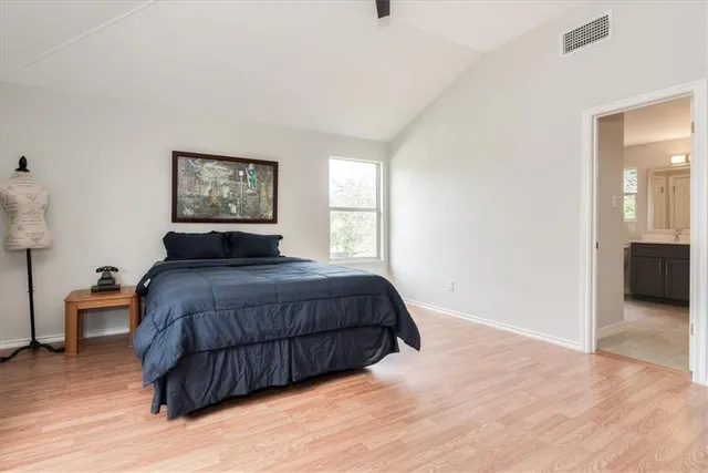 a bedroom with a bed and a painting on the wall