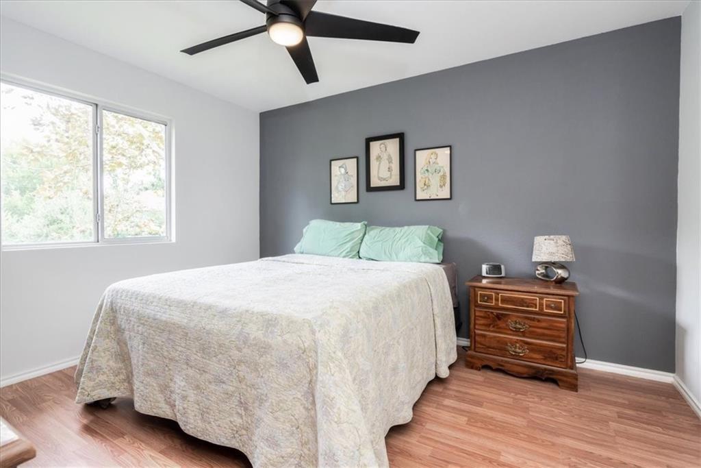 20805 Jumpers Delight Lane Pflugerville, TX 78660 - Photo 20 of 24 Bedroom featuring wood finished floors and a ceiling fan