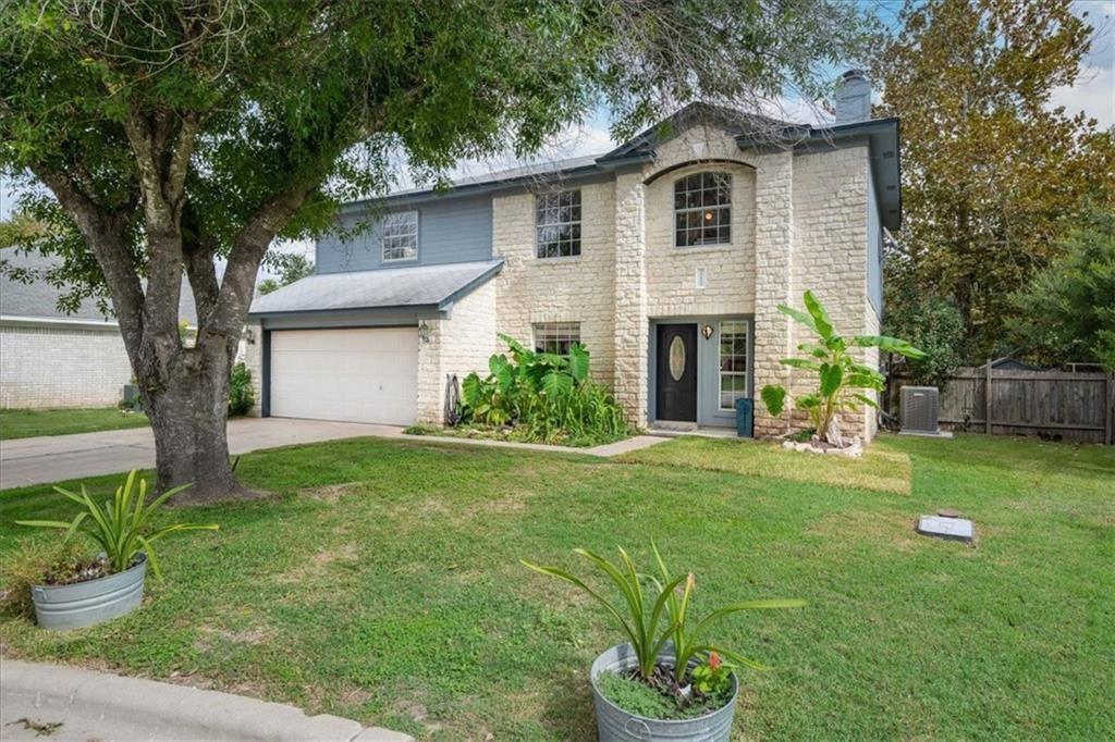 20805 Jumpers Delight Lane Pflugerville, TX 78660 - Photo 22 of 24 View of front of home featuring a chimney, an attached garage, driveway, and stone siding