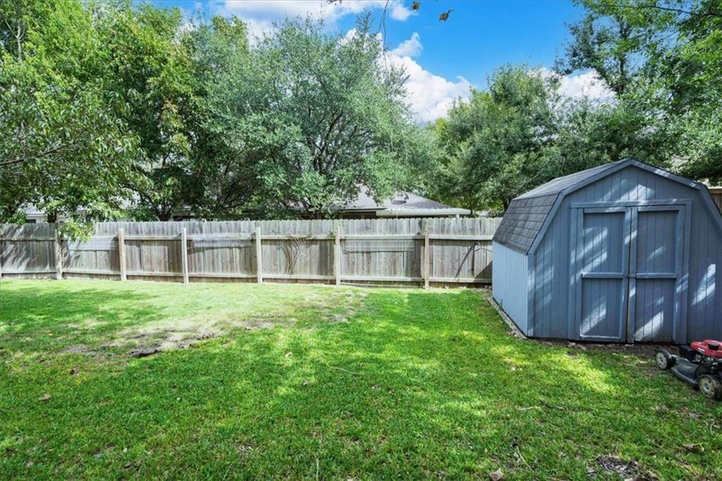 20805 Jumpers Delight Lane Pflugerville, TX 78660 - Photo 24 of 24 Fenced backyard with a storage unit