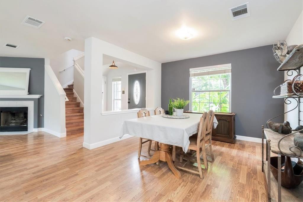 20805 Jumpers Delight Lane Pflugerville, TX 78660 - Photo 5 of 24 Dining space featuring light wood-type flooring, healthy amount of natural light, and a fireplace