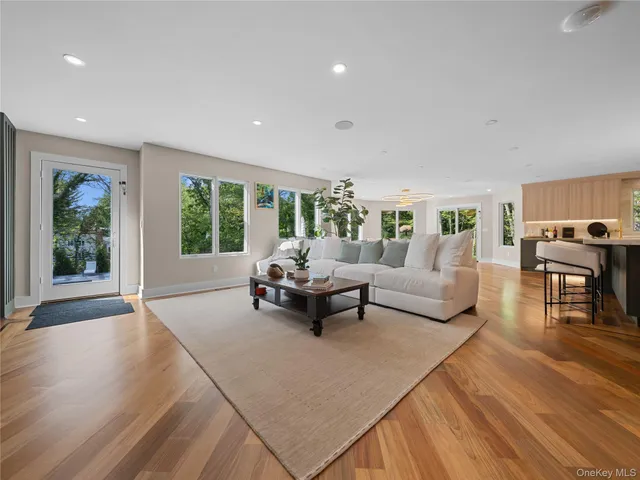 a living room with furniture and large windows