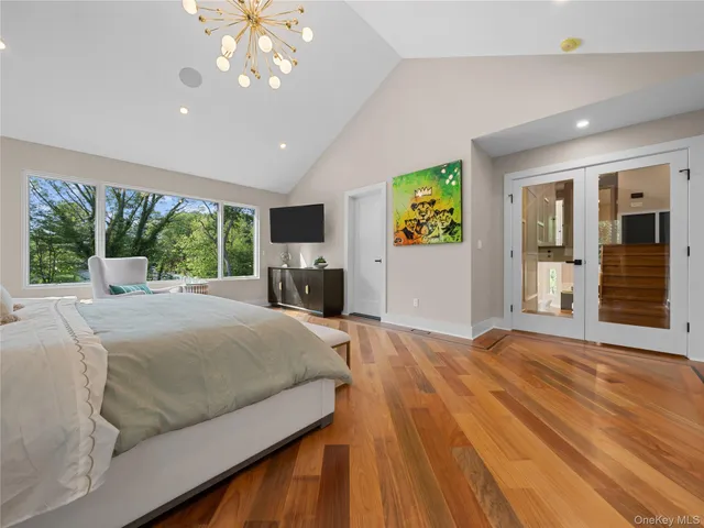 a bedroom with a large bed and a large window