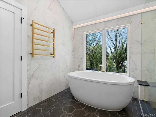 a bathroom with a granite countertop sink a toilet and a shower