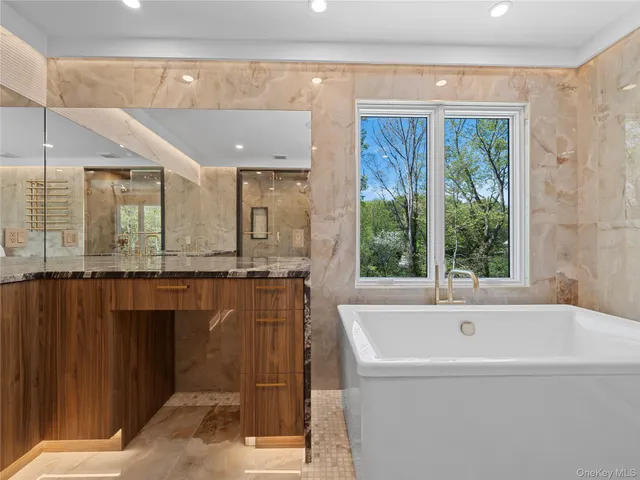 a bathroom with a bathtub and window