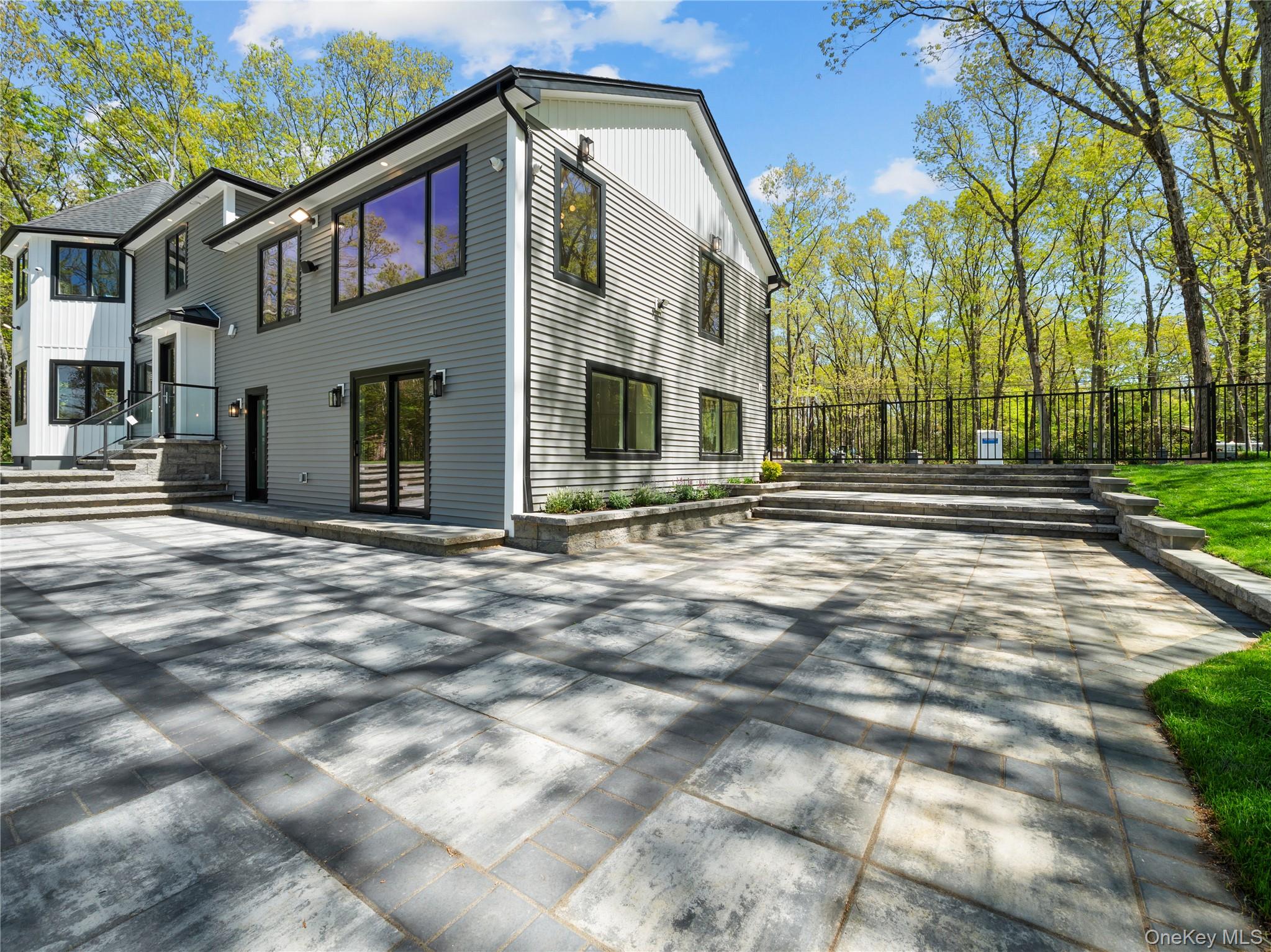 5 North Hills Road East Norwich, NY 11732 - Photo 4 of 50 a front view of a house with a yard