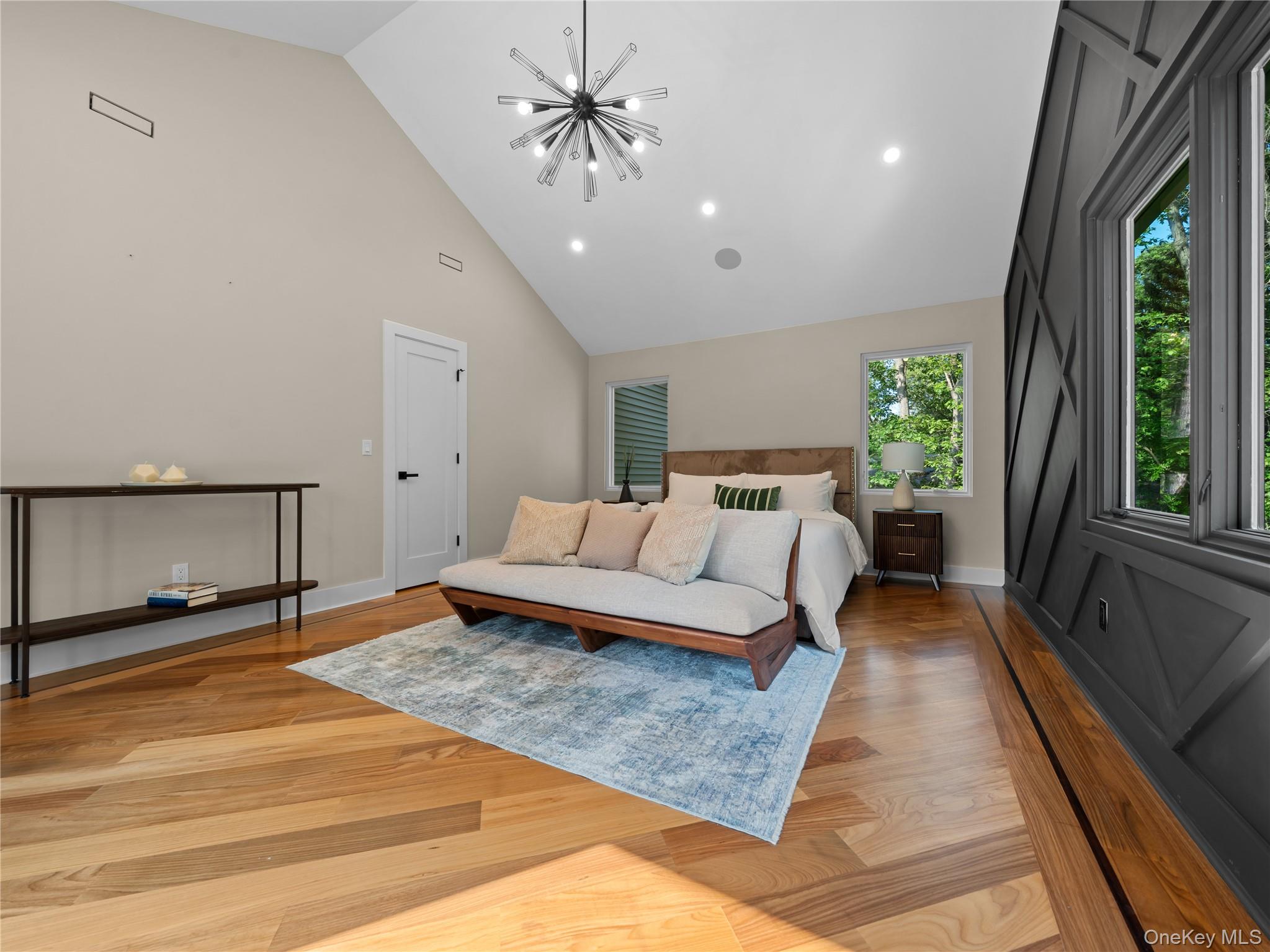 5 North Hills Road East Norwich, NY 11732 - Photo 41 of 50 a bedroom with a large bed and a chandelier