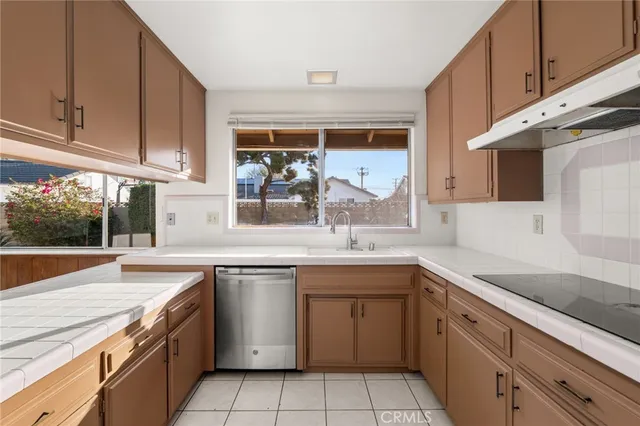 a kitchen with a sink stove and cabinets