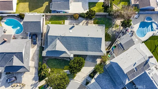 an aerial view of a house with garden space and street view