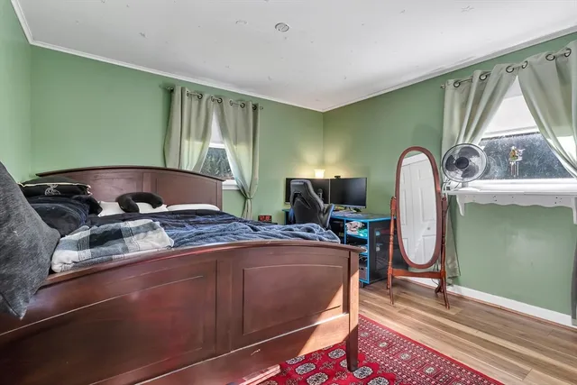 a bed sitting in a room next to a window