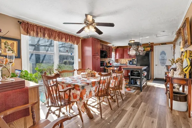 a view of a dining room with furniture window and wooden floor