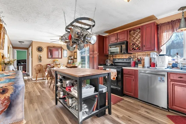 a kitchen with stainless steel appliances granite countertop a stove and cabinets