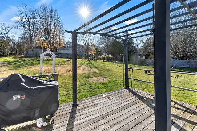 a view of a wooden deck with a yard