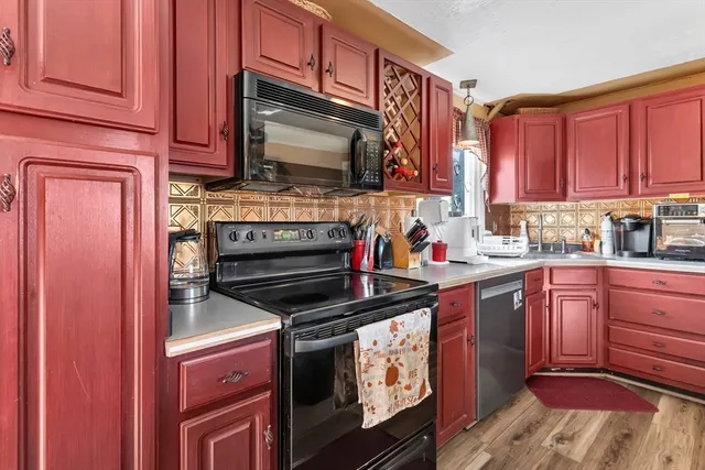 a kitchen with stainless steel appliances a stove a microwave sink and cabinets